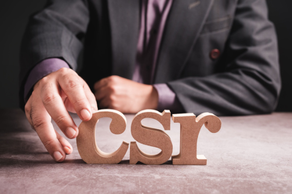 Man spells out CSR with wooden blocks.